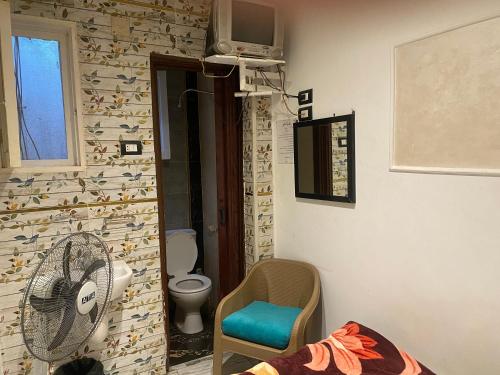 a room with a bathroom with a toilet and a fan at Shaheen hotel in Suez