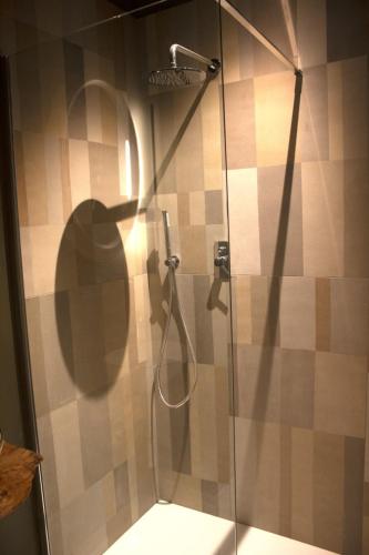 a shower with a glass door in a bathroom at Appartamento PALE 2 posti letto in Pale