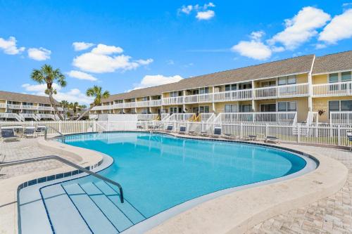 a large swimming pool in front of a building at Sandpiper Cove by Panhandle Getaways in Destin