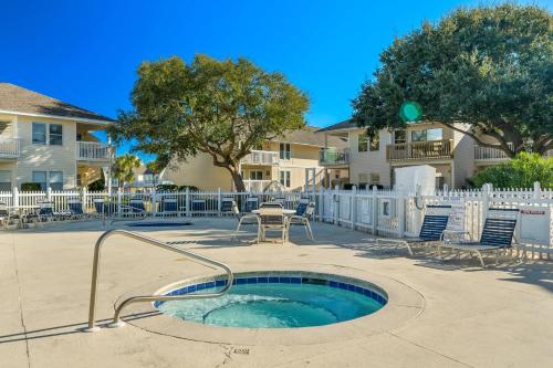 a hot tub in a patio with chairs and a table at Sandpiper Cove by Panhandle Getaways in Destin
