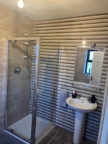a bathroom with a shower and a sink at Bragan Mountain View in Monaghan