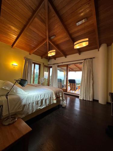 a bedroom with a bed with a view of the ocean at Casa Valdres in Santa Cruz La Laguna