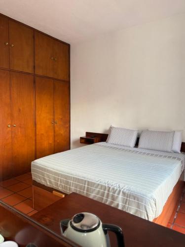 a bedroom with a bed and a wooden cabinet at Beautiful Room in the montains in Estrela