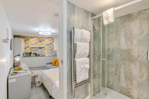 a bathroom with a shower and a bed in a room at 1 Bed in Penzance oc-u34132 in Penzance