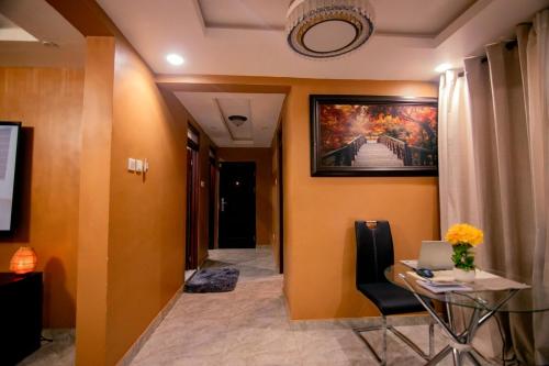 a hallway with a table and a painting on the wall at Classic Apartment at Tema Community 26 in Tema