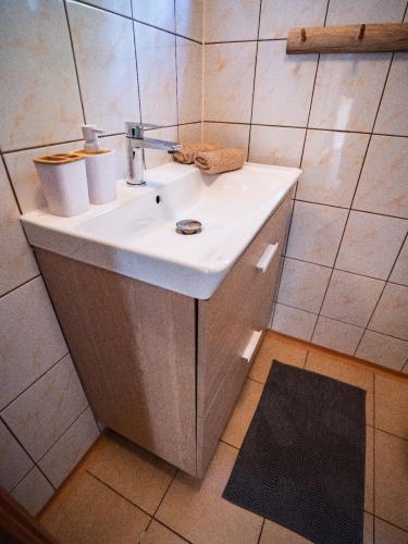 a bathroom with a white sink and a mirror at Laguna Turawa in Turawa