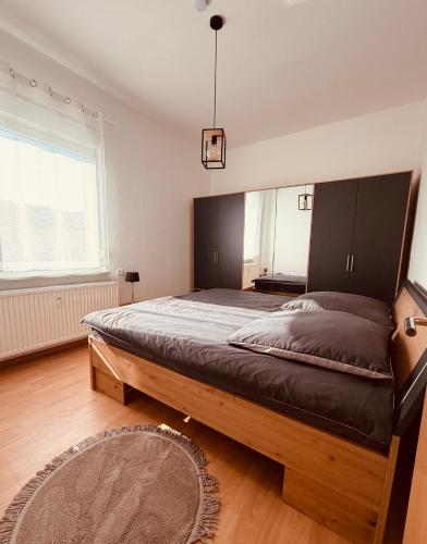 a bedroom with a large bed in a room at Haus an der Linde in Bad Essen