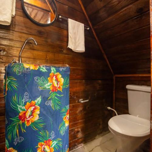 a bathroom with a toilet and a towel at Colinas do braga chalés in Brumadinho