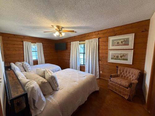 a bedroom with two beds and a ceiling fan at The Piney Woods Cabin in Nacogdoches