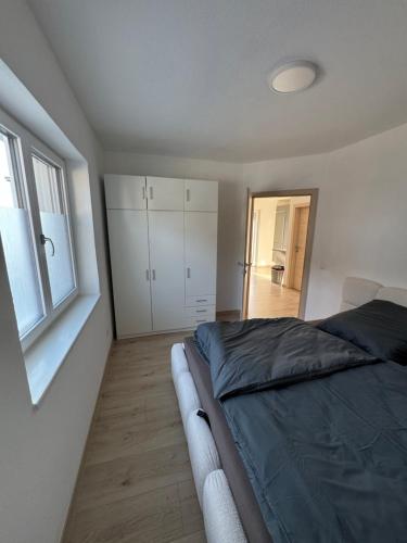 a bedroom with a bed and a window at Loft05 in Wankham