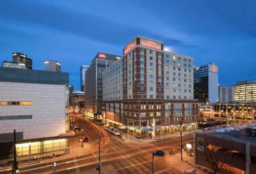 a city at night with a street with cars at Hilton Garden Inn Denver Downtown in Denver