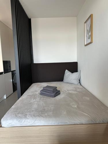 a bed in a room with towels on it at Apartment Kysucká 1014 Top Floor & View in Košice