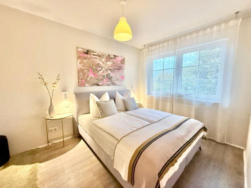 a bedroom with a bed and a window at Das Haus am Weinberg in Ensch