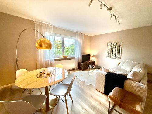 a living room with a table and a couch at Das Haus am Weinberg in Ensch