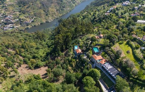 an aerial view of a house on a hill next to a river at ALDEIA DA MARGARIDA in Tarouquela
