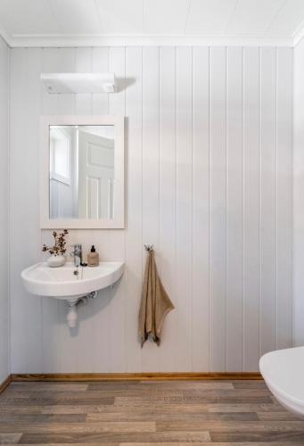 a bathroom with a sink and a mirror at Villa Nygård in Jelsa