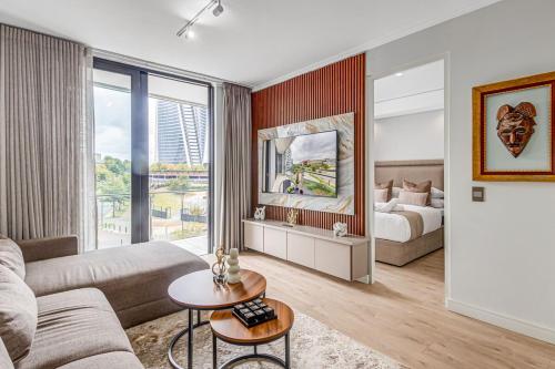 a living room with a couch and a bed at Heatherstone Haven in Midrand