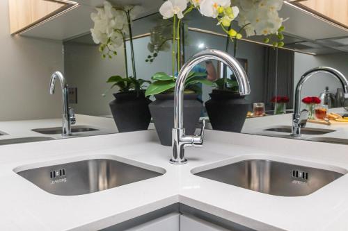 a kitchen with two sinks and two faucets at Heatherstone Haven in Midrand