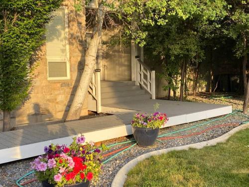 a house with two pots of flowers in the yard at Lehi East Bench Private Studio! in Lehi