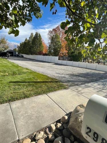 a street with a white fence and a road at Lehi East Bench Private Studio! in Lehi