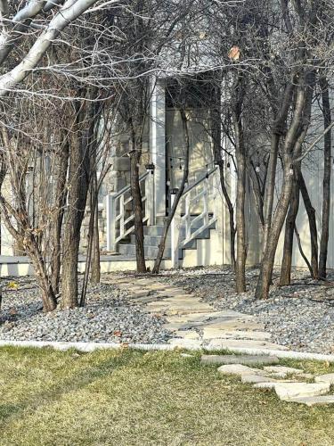 a stone path in front of a building with trees at Lehi East Bench Private Apt! in Lehi
