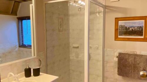 a bathroom with a shower and a sink at Highlander in Dinner Plain