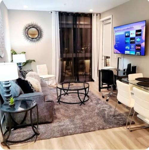 a living room with a couch and a table at Spacious 2 bed 2 bath, Pool, Hottub, Wifi, 24 hr Fitness, Parking in Los Angeles