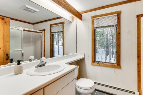 a bathroom with a sink and a toilet and a window at Resort-Style Community! Quechee Chalet w/ Deck in Quechee
