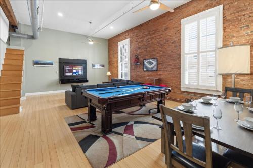 a living room with a pool table and a tv at 1800 Sq Ft Loft Downtown Near Convention Center in Indianapolis