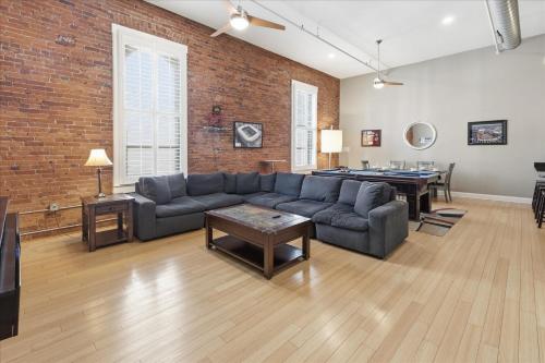 a living room with a couch and a pool table at 1800 Sq Ft Loft Downtown Near Convention Center in Indianapolis