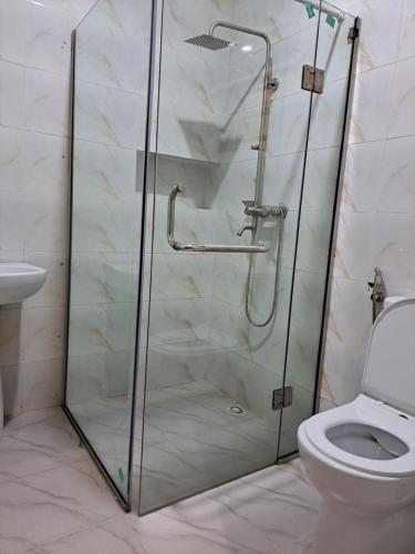 a shower stall in a bathroom with a toilet at Diolux Peaceful Stay in Sangotedo
