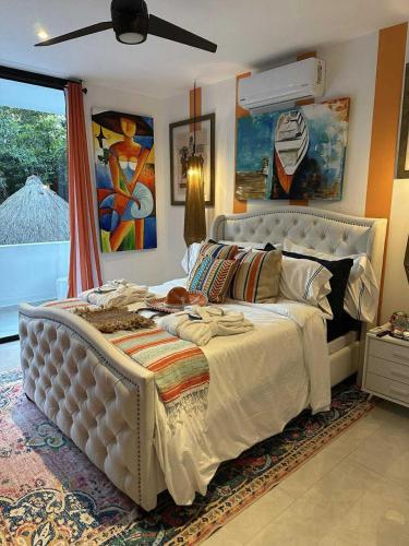 a bedroom with a large white bed and a window at Casa Azul-Xpuha, Tulum, Mexico in Xpu Ha