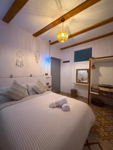 a bedroom with a large white bed with towels on it at Dar Diamante Azul in Chefchaouen