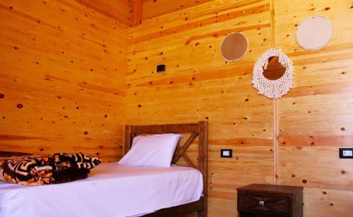 a bedroom with a bed in a wooden wall at Dagal Camp - دجل كامب in Sharm El Sheikh