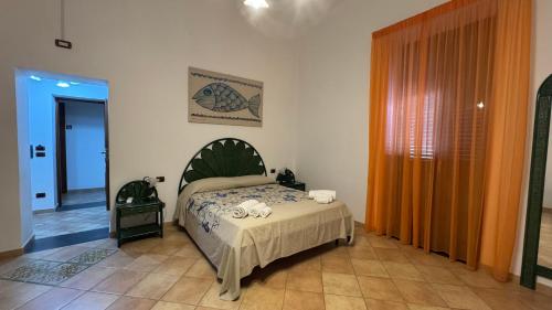 a bedroom with a bed in a room at Hotel Principe di Rinella in Leni