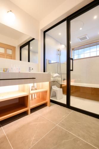 a bathroom with a sink and a shower and a toilet at Love&Peace Resort in Shima