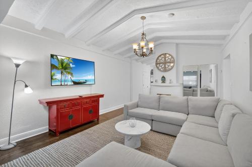 a living room with a couch and a red table at Casa Santorini - Chic 4 2 near Grove & Brickell in Miami
