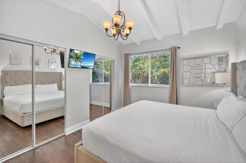 a white bedroom with a bed and a window at Casa Santorini - Chic 4 2 near Grove & Brickell in Miami