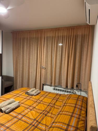a bedroom with a bed with two towels on it at Karen Sofia Modern Appartament in Opera