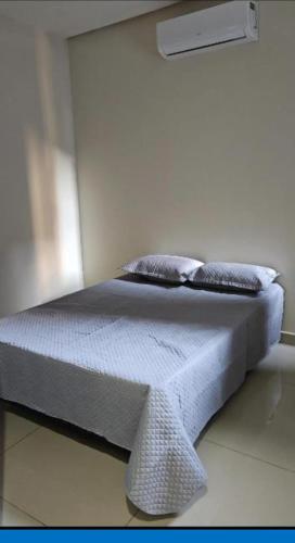 a bed in a white room with at JMS Refuge in Pirapora