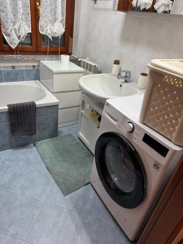 a washing machine in a bathroom next to a sink at Karen Sofia Modern Appartament in Opera