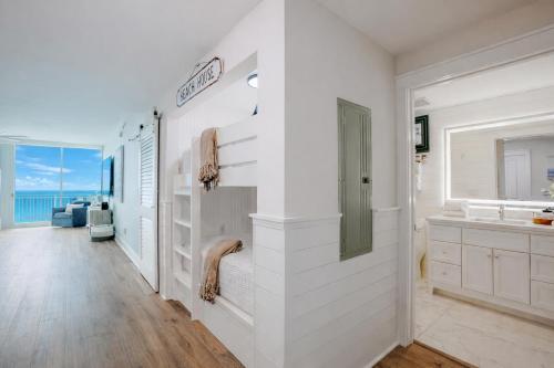 a white bathroom with a sink and a counter at Ocean Blue at 1805 Aqua in Panama City Beach