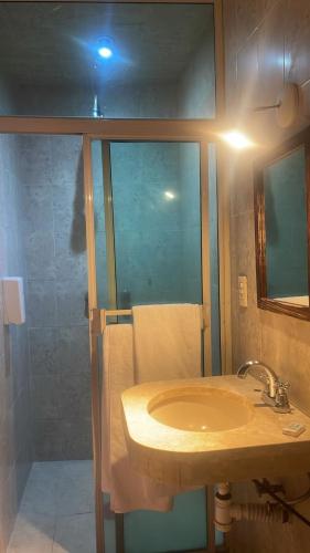 a bathroom with a sink and a shower at Hotel Santo Domingo in Zacatecas