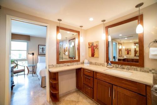 a bathroom with a sink and a large mirror at Nani Kai Hale 308 in Kihei