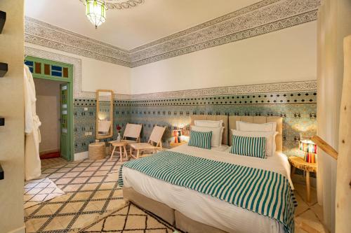 a bedroom with a large bed in a room at Riad Dar Lamia Marrakech Médina in Marrakesh