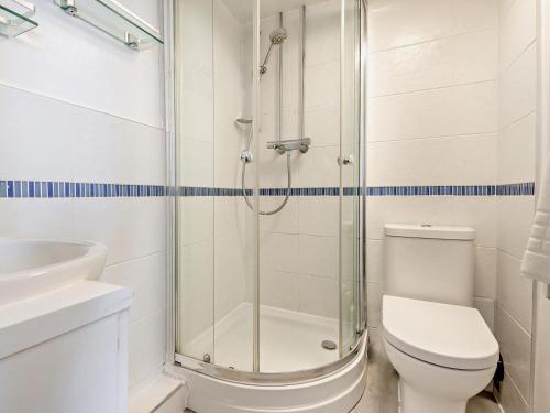 a bathroom with a shower and a toilet and a sink at 2 Bed in Holt oc-78478 in Blakeney