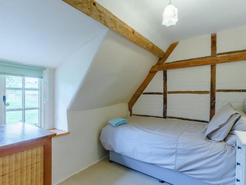 a bedroom with a bed and a window at 3 Bed in Dorchester oc-dc089 in Whitcombe