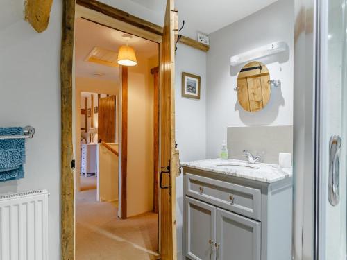 a bathroom with a sink and a mirror at 3 Bed in Dorchester oc-dc089 in Whitcombe