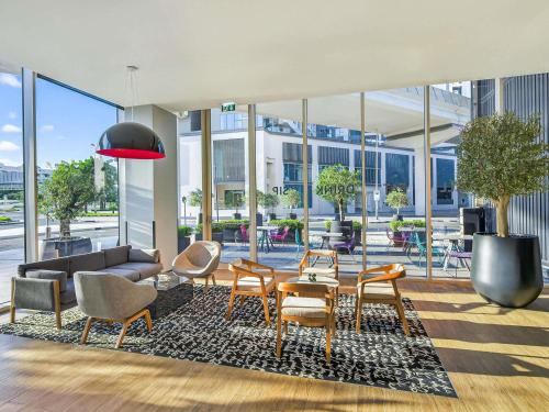 a living room with a couch and chairs and a table at ibis Styles Dubai Airport Hotel in Dubai