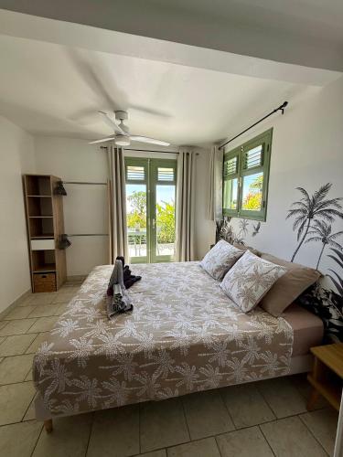 a bedroom with a large bed and a window at Gîte Ti Volkan in Saint-Claude